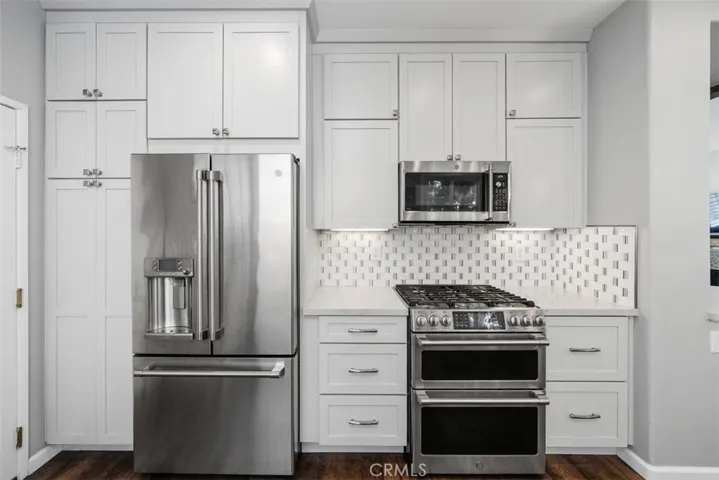 Stainless steel appliances and custom cabinetry create a clean, timeless design.