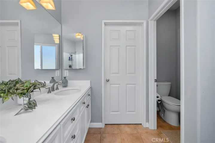 Secondary closet inside master bathroom offering his and hers closets