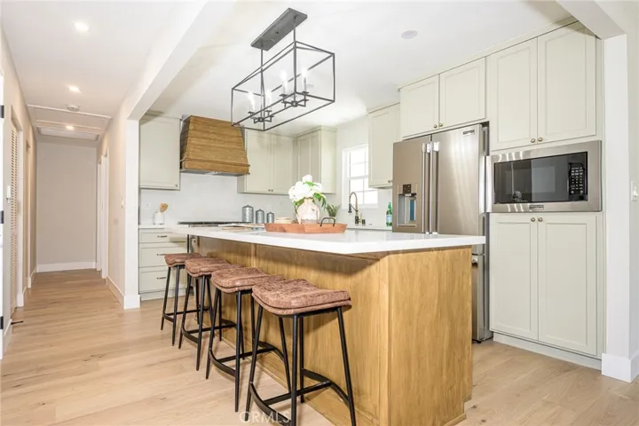 At the center of the home is a stunning kitchen designed for gathering and entertaining