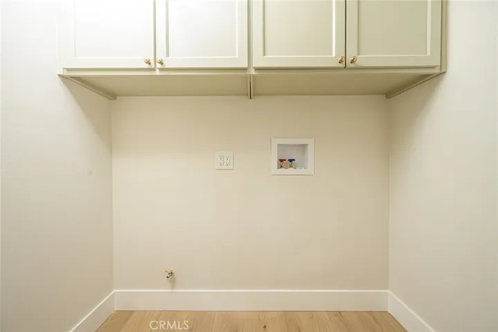 Indoor laundry with built in storage cabinets