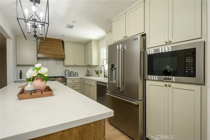 New custom cabinetry with sleek new countertops with ample prep space
