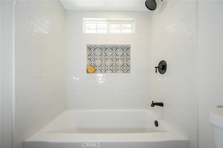 Hall bathroom with new tub and tile surround
