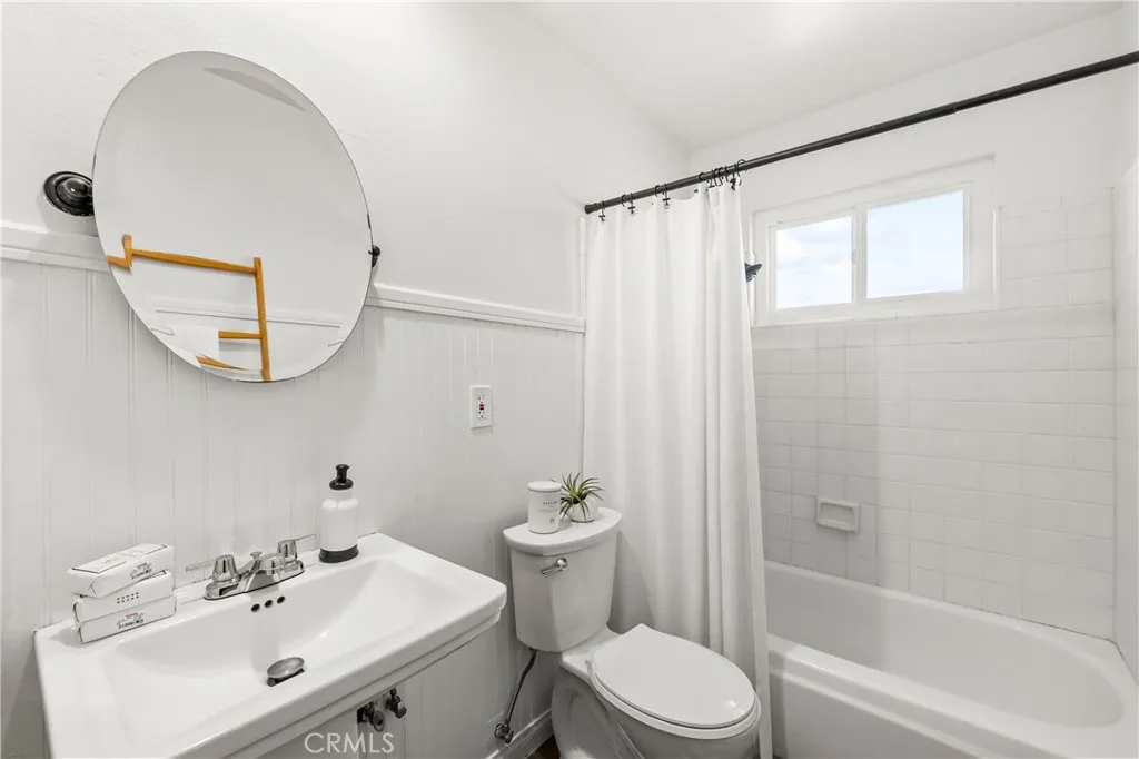 Full bath-lots of possibilities- easy to expand with larger vanity or storage. Freshly painted with new toilet.