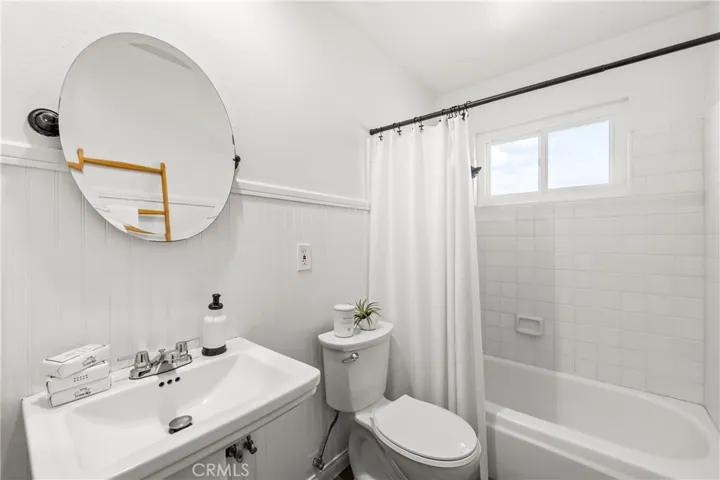 Full bath-lots of possibilities- easy to expand with larger vanity or storage. Freshly painted with new toilet.
