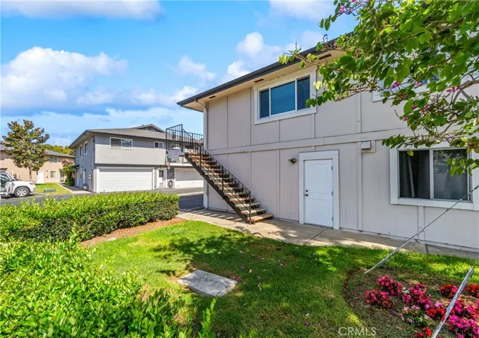 Stairs to unit,  lower door is your  direct access to shared garage with generous secure storage spaces.