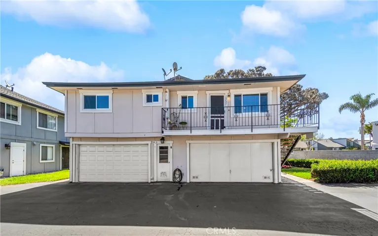 Upper end unit on the right/shared garage directly underneath with green space  to the right.