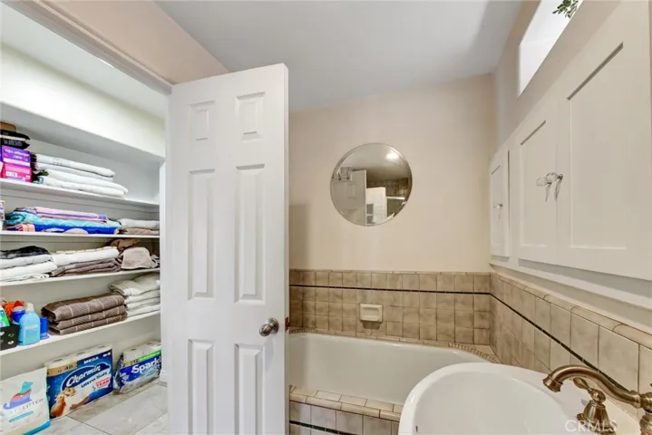 Second bathroom with linen storage in the hallway