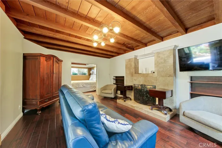 View of living room with fireplace and built-in bookshelves