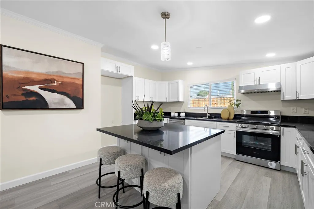 Gourmet Kitchen with Granite Countertops, Center Island with Seating, Stainless Appliances, and Custom White Shaker Self-Closing Cabinetry