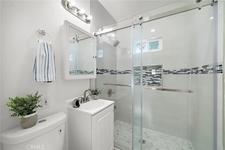 Guest Bathroom with All New Fixtures, Designer Tile, and Clear Glass Enclosure