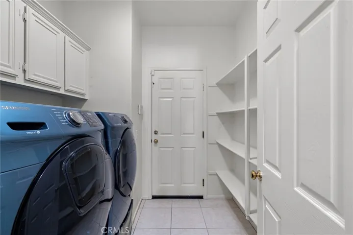 Laundry room and extra pantry space. Door to the garage