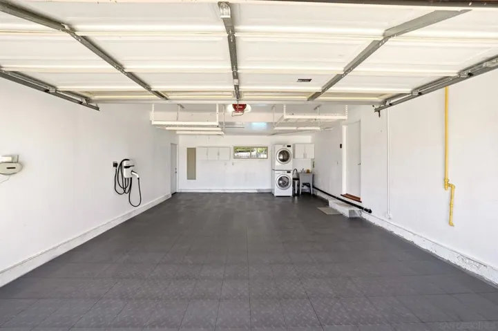 Drywalled and flooring added. Wall has dedicated EV charging outlet for your electric vehicle.