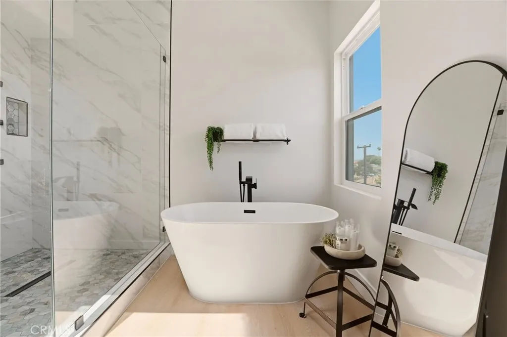 Separate bathtub and walk in shower in primary bathroom