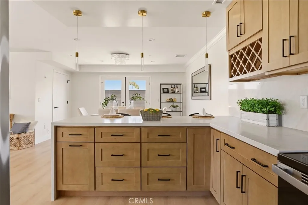 Quartz waterfall counter with seating off of kitchen