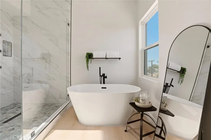 Separate bathtub and walk in shower in primary bathroom