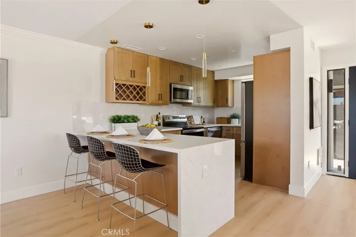 Quartz waterfall counter with seating off of kitchen