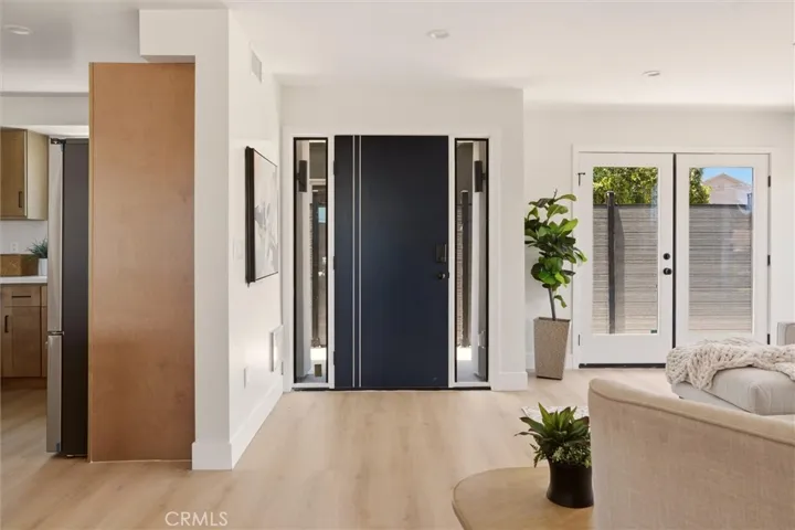 View of front entrance and patio access from living room
