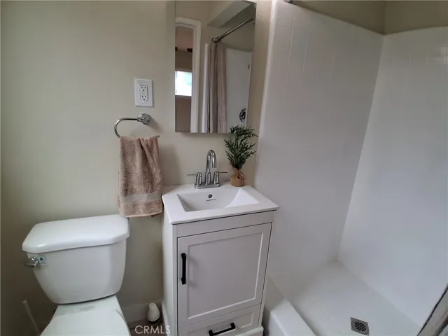 Updated primary bathroom with a fresh coat of tile glaze and paint