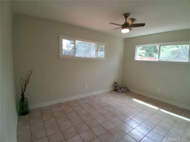 Fourth Bedroom Primary, bright and comfortable, featuring a new window and ceiling fan for added comfort and natural light.
