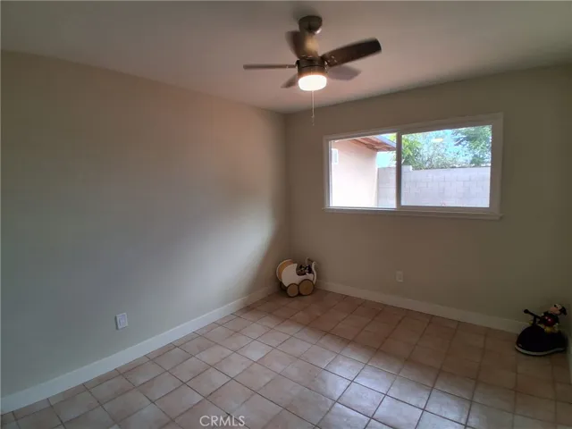 Second Bedroom, bright and comfortable, featuring a new window and ceiling fan for added comfort and natural light.