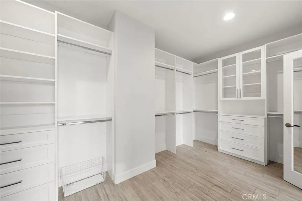 Large closet with closet organizers.
