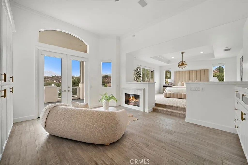 Spacious primary suite large custom built in cabinetry and fireplace.