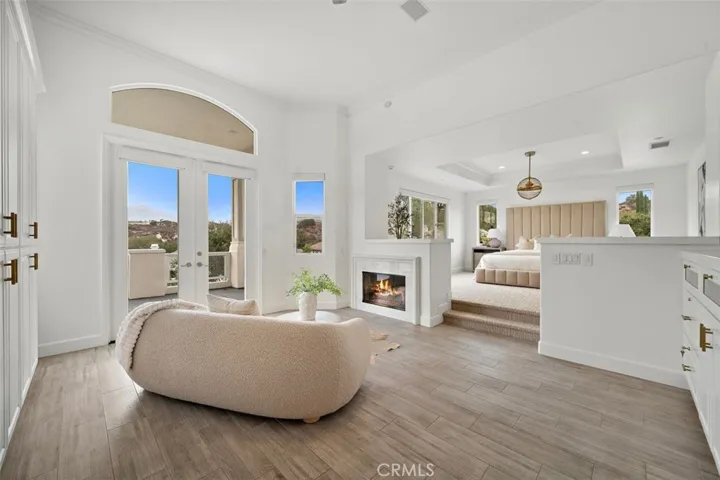 Spacious primary suite large custom built in cabinetry and fireplace.