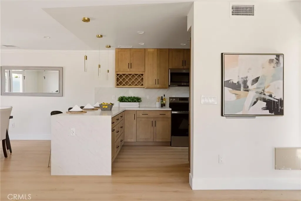 Waterfall countertop separates kitchen from dining space, photo from Unit A (nearly identical unit)