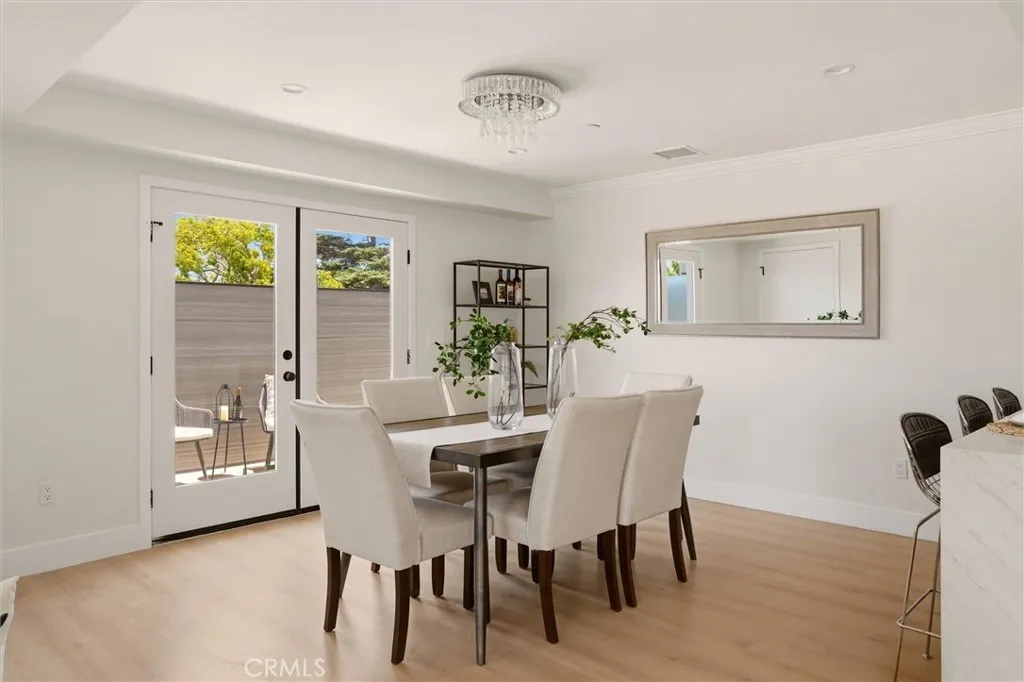 Staged dining area with access to patio, photo from Unit A (nearly identical unit)