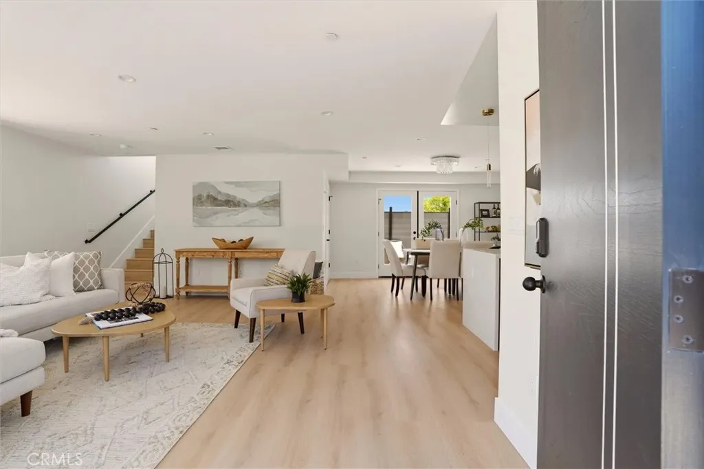 View of staged living space from front entrance, photo from Unit A (nearly identical unit)