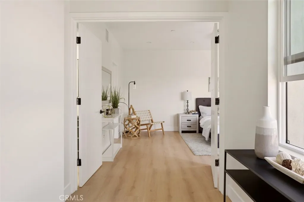 View into primary bedroom, photo from Unit A (nearly identical unit)
