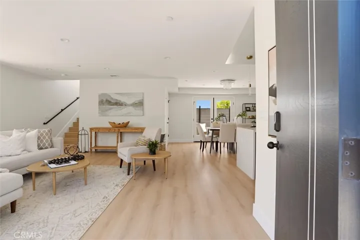 View of staged living space from front entrance, photo from Unit A (nearly identical unit)