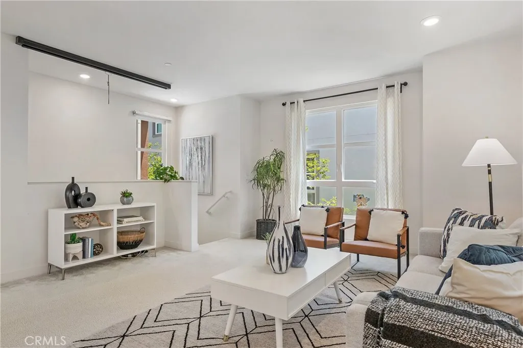 Living room area leading down to main stairway and entrance