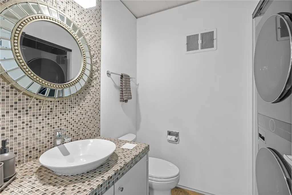 downstairs half bathroom with washer dryer