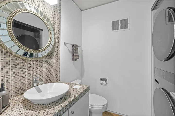 downstairs half bathroom with washer dryer