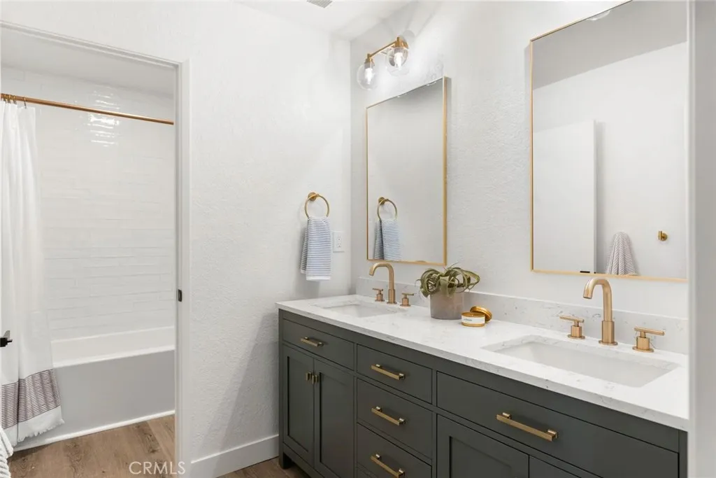 Updated guest bath with tub/shower combo and dual sink vanity.