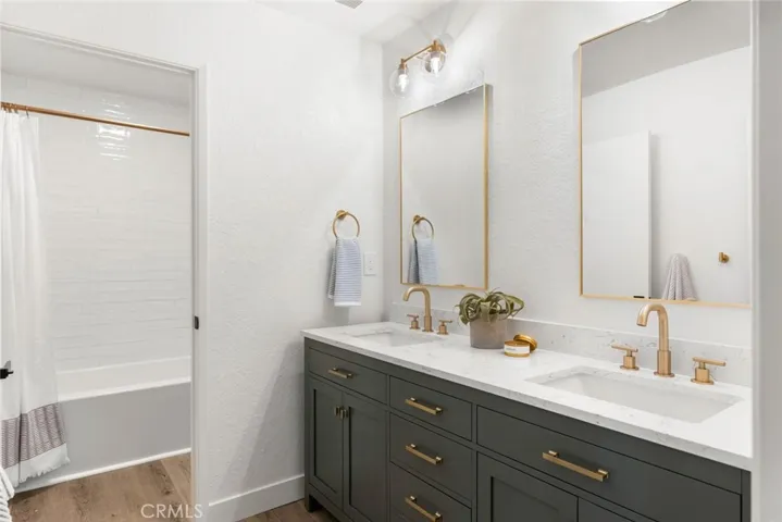 Updated guest bath with tub/shower combo and dual sink vanity.
