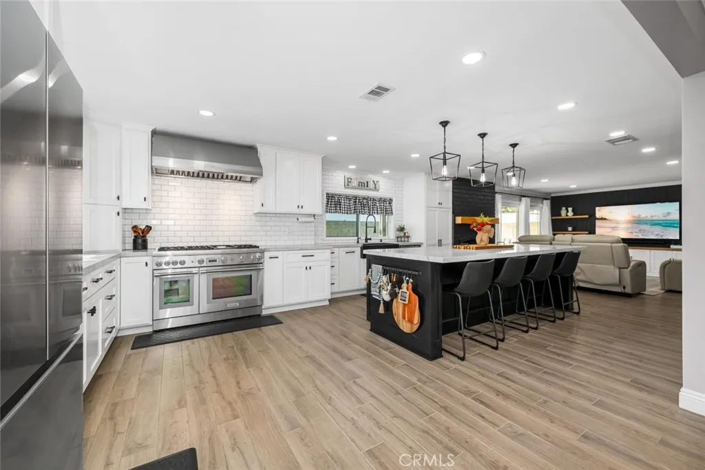 A chefs dream kitchen features center island, pendant lights, amble storage.