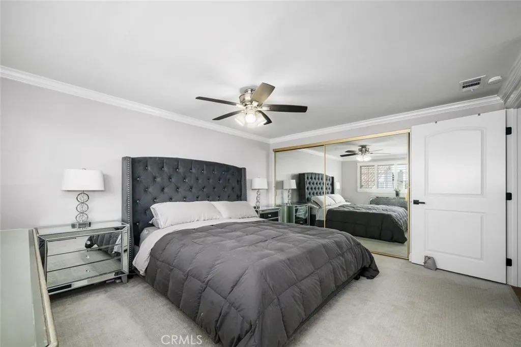 Classic panel bedroom doors line the hallway.  Double wide closet with mirror