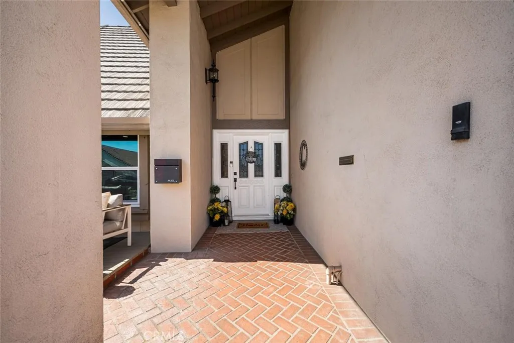 Curb appeal features brickwork leading to a beautiful front door with sidelight panels.