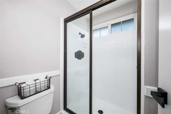 Refinished shower tile and new shower door for a modern look.