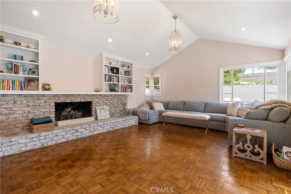 Family room in the rear of the home features a cozy fireplace and built-in​​‌​​​​‌​​‌‌​​‌​​​‌‌​​​‌​​‌‌​​‌‌​​‌‌​​​​ shelves