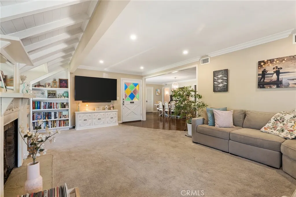 View from the living room toward the front door and dining.