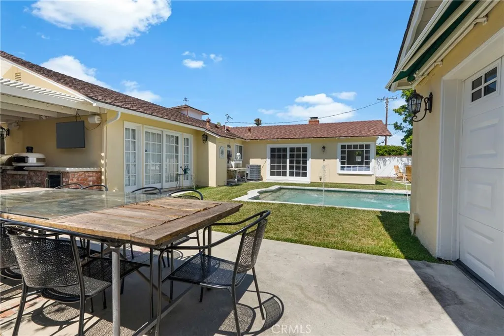 View from the outdoor dining area toward the pool and the family room.