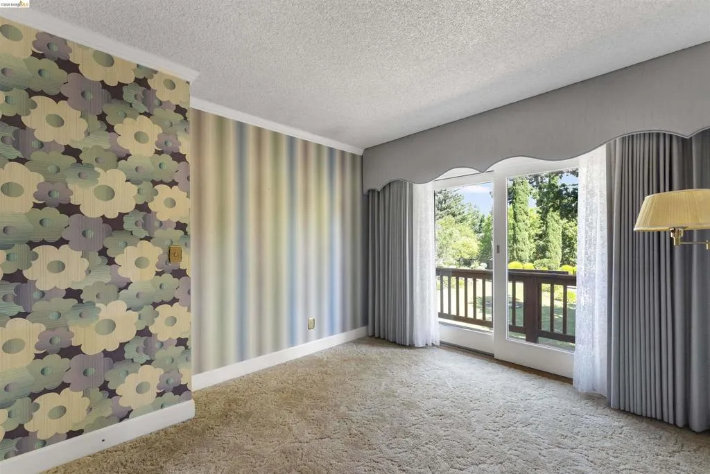Sliding glass door opening to an outdoor area with wooden railing