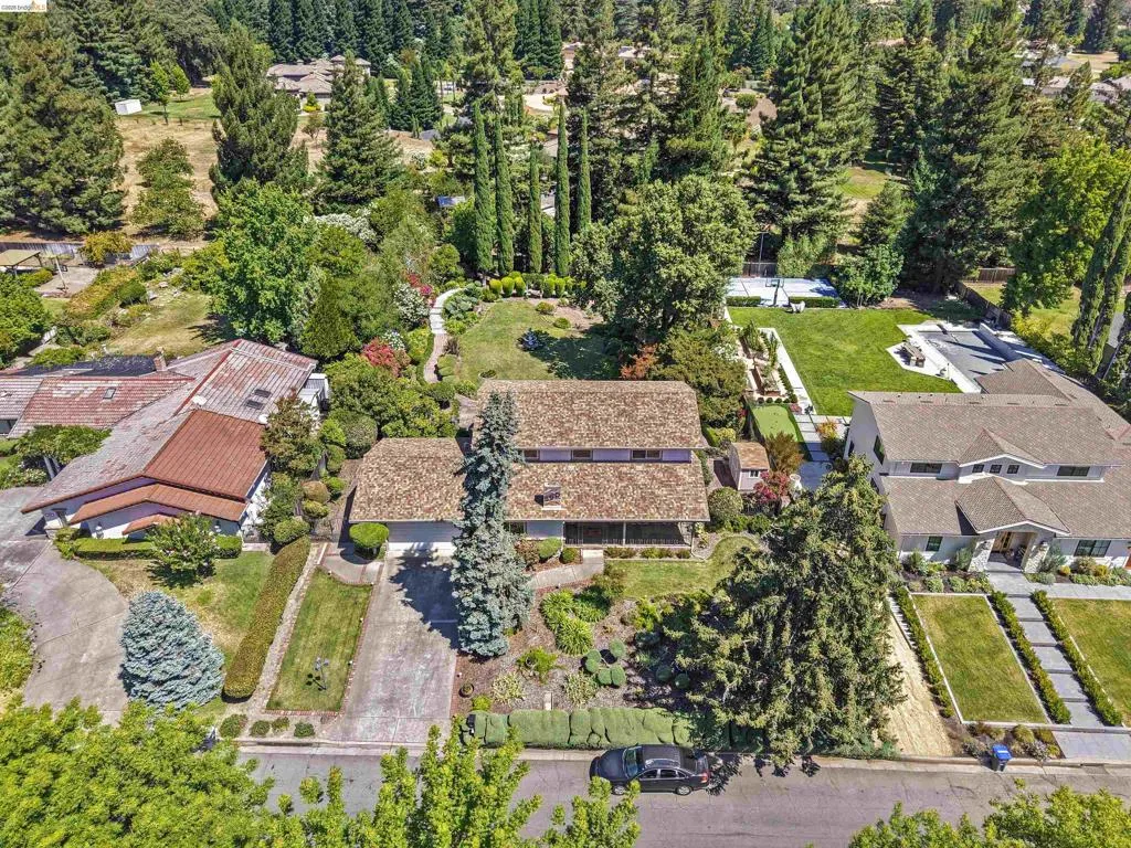 Expansive property featuring mature trees and lush landscaping