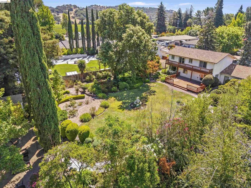 Expansive property featuring a two-story residence with a ground-level deck and upper-level balcony