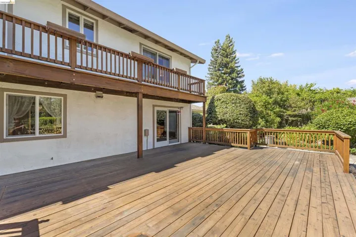 Spacious multi-level wood deck with natural wood railing