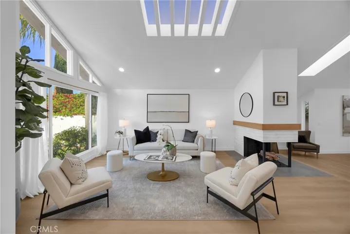 Living room with vaulted ceilings and skylights