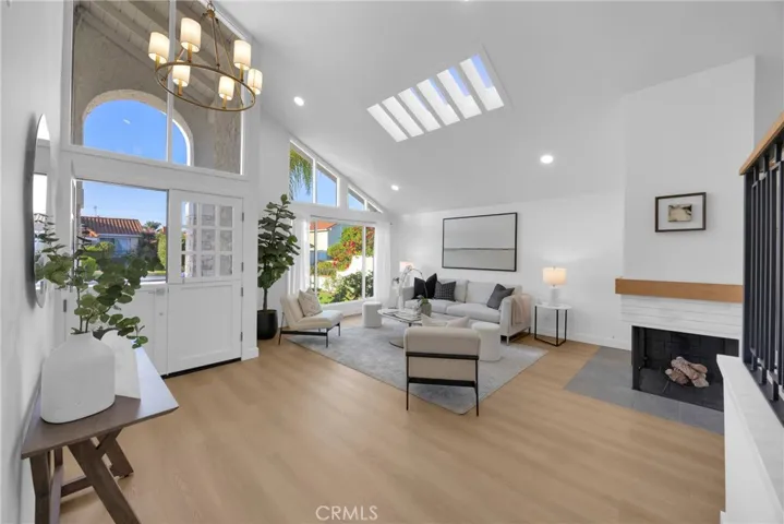 Living room with vaulted ceilings and skylights